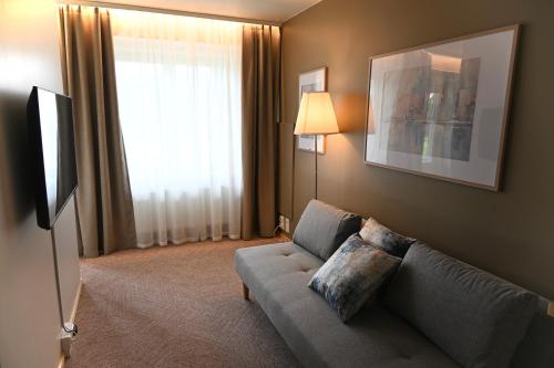 a living room with a couch and a window at Boutique hotel SAVOIR in Savonlinna