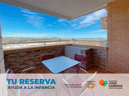 a table and chairs on a balcony with a view at Apartamentos Costamar 3000 in Torre de la Sal