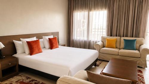a hotel room with a bed and a couch at AB Business Hôtel in Nouakchott