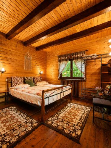 a bedroom with a bed in a wooden room at Old Mark's House Sinaia in Sinaia