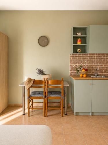 a kitchen with a table and two chairs and a sink at Anastasis Apartments in Trapezaki