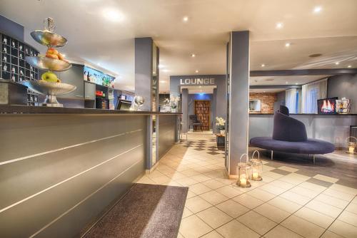a lobby with a bar and a chair in a room at enjoy hostel Berlin City West in Berlin