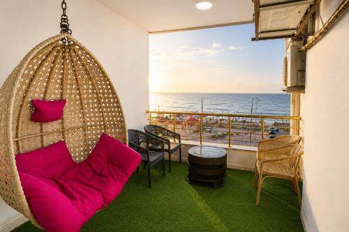 a room with a swing and a view of the ocean at Skyline Homes in Alexandria