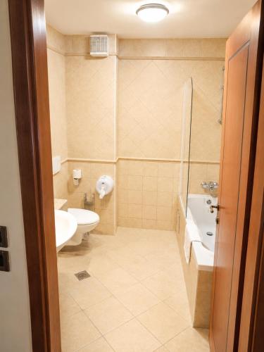 a bathroom with a sink and a toilet and a shower at Hotel Laguna in Privlaka
