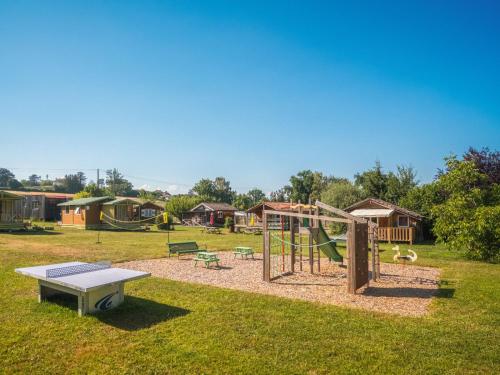 a park with a playground with a swing at Camping Léman Plage in Excénevex