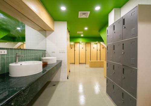 a bathroom with two sinks and a green ceiling at 3BU Hostel Baguio - Bonifacio in Baguio