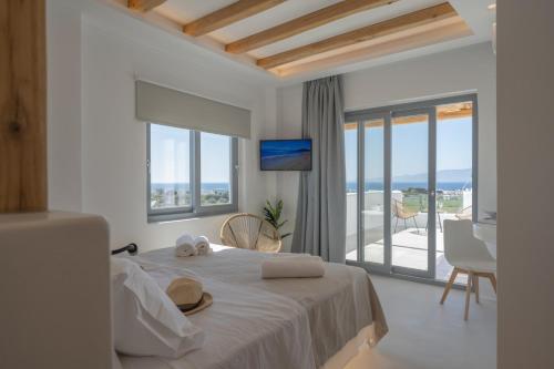 a bedroom with a bed with a view of the ocean at Kastraki Riviera Suites in Kastraki