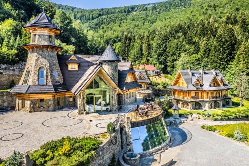 an aerial view of a house with a tower at Krupówka Mountain Resort Wellness & SPA Szczyrk in Szczyrk