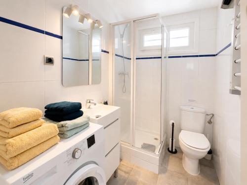 a white bathroom with a sink and a toilet at Les cases del vent I in L'Ametlla de Mar