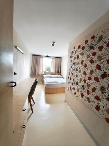 a bedroom with a bed and a flower wall at Loft Hause Sopot in Sopot