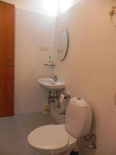 a bathroom with a toilet and a sink at Shiva Valley Retreat in Calangute
