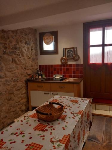 a kitchen with a table with a basket on it at La Petite Maison de Caractere Catalan in Argelès-sur-Mer