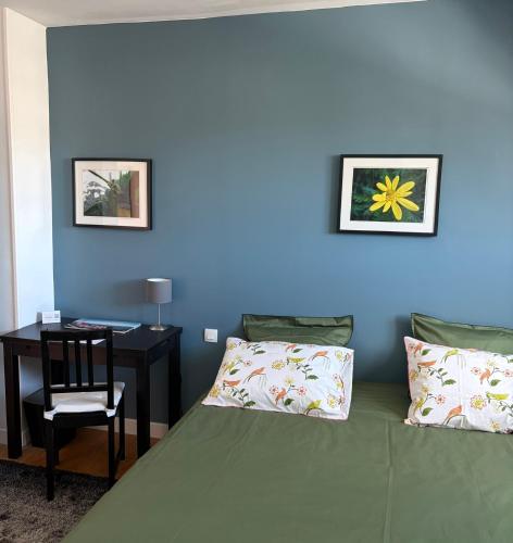 a bedroom with a bed and a desk with a chair at Ty-Aganisia Breizh in Perros-Guirec