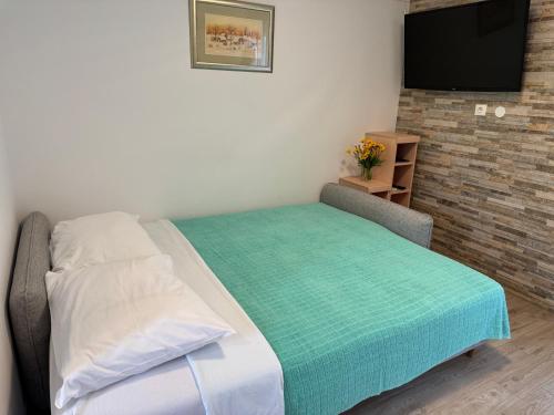 a bedroom with a bed and a television in it at Villa Pinija in Fažana