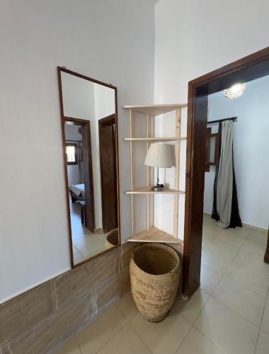 a room with a mirror and a basket and a lamp at Lighthouse Residence in Dahab