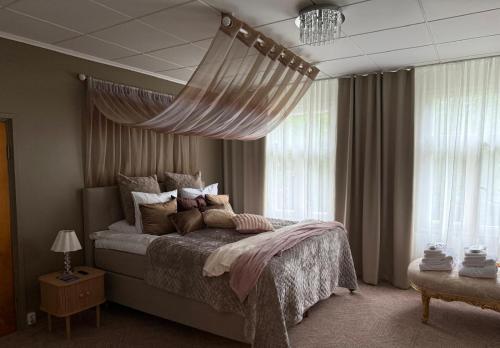a bedroom with a large bed and a window at Boutique hotel SAVOIR in Savonlinna