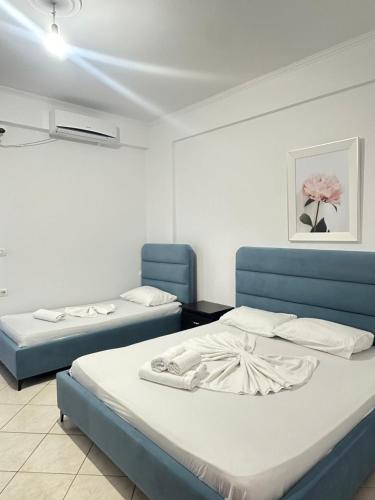 two beds in a room with two blue beds at Vila Llaka in Himare