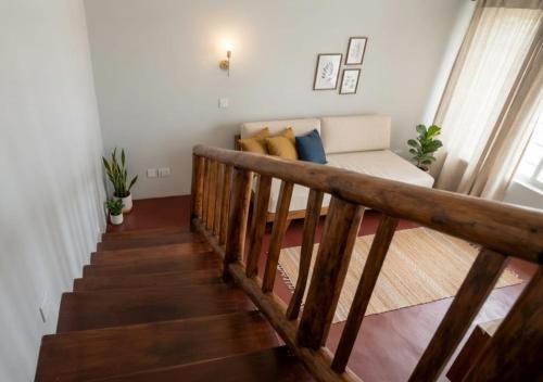 a staircase with a couch in a living room at Ella Nature viwe Lodge in Ella