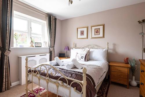 a bedroom with a bed and a window at 4 Bedroom Town House with Parking in Shrewsbury