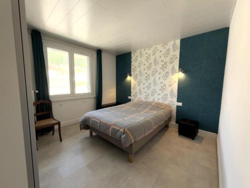 a small bedroom with a bed and a window at Au cœur de Maîche in Maîche