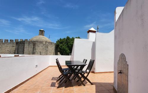 ein Tisch und Stühle auf dem Balkon eines Hauses in der Unterkunft Casa Yalbash in Elvas