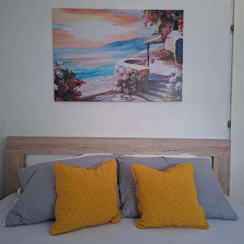 a painting hanging above a bed with two pillows at Top Topla - Herceg Novi in Topla