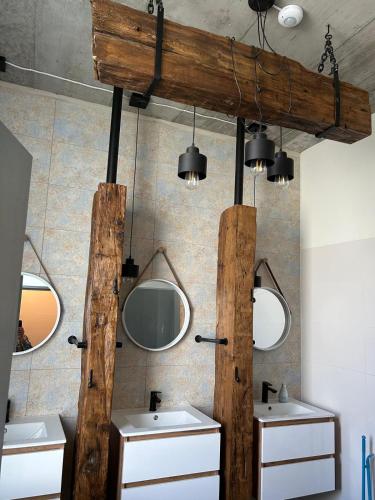 a bathroom with two sinks and two mirrors at Noclegi Kolejowa in Rybnik