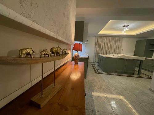a living room with a table with figurines on it at Villa Dino in Kalithies