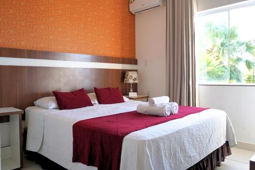 a bedroom with a large bed with towels on it at Hotel Vivere Cataratas in Foz do Iguaçu