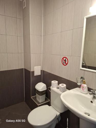 a bathroom with a toilet and a sink at Вила Арапя in Tsarevo
