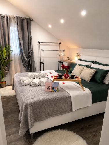 a bedroom with a large bed with a table on it at Luxury Apartment Megy in Otočac