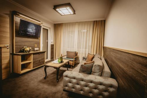 a living room with a couch and a television at Hotel ZOO Sofia in Sofia