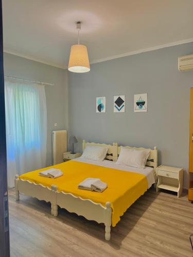 a bedroom with a large yellow bed in it at Captain Michalis house in Parga