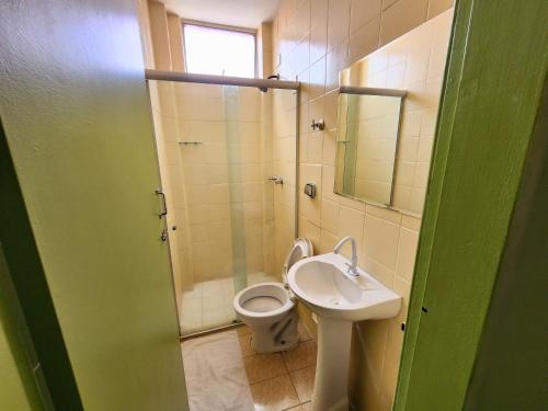 a bathroom with a toilet and a sink and a shower at Guarany Hotel Express in João Pessoa