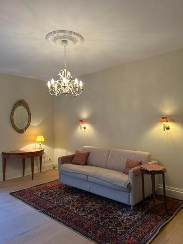 a living room with a couch and a chandelier at Agen centre in Agen