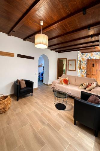 a living room with a couch and a table at Apartamento BAÑOS ÁRABES DEL CENIZAL antes Plaza de las Fuentes in Toledo