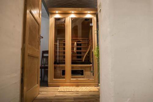 a hallway with an open door to a room at Bonaluti Adults - Azyl Dla Dorosłych in Mirsk
