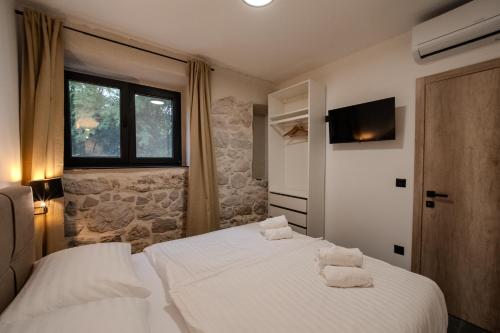 a bedroom with two beds with towels on them at Tramontana Iž in Veli Iž
