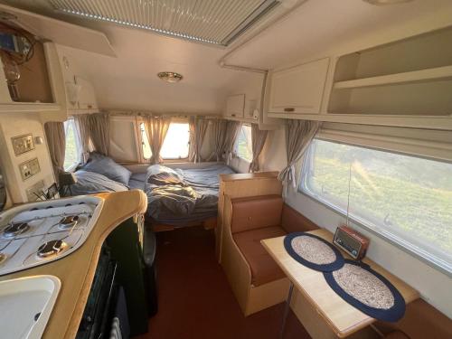 an interior view of an rv with a kitchen and a stove at Weź Wyjdź - Podlaski Glamping in Łazy
