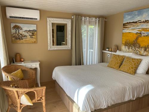 a bedroom with a bed and a window at Rêves & Rivière in Rivière
