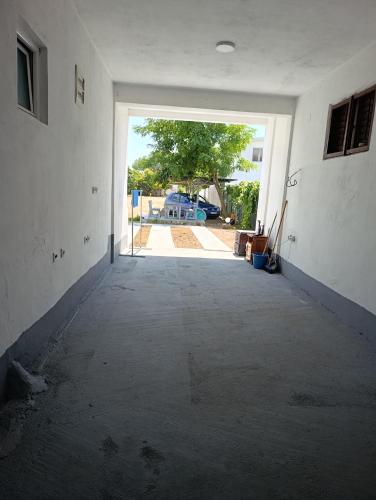 an empty room with an open door to a yard at Villa Serenita in Ulcinj