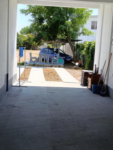 an open door to a yard with a car parked at Villa Serenita in Ulcinj