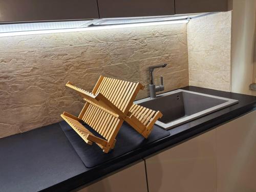 a kitchen counter with a sink and two chairs on it at Appartamento in centro storico. in Camaiore