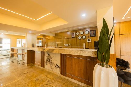 a large kitchen with a long counter with a plant in a vase at Dodos Hotel Services in Port Harcourt