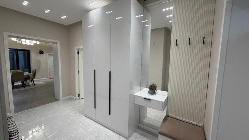 a bathroom with a white sink and a mirror at Modern Villa in Quba City Center in Quba