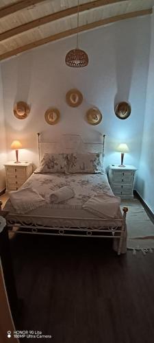 a bedroom with a bed with two lights on the wall at Cantinho do Frangoneiro in Fortios