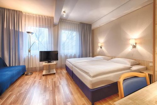 a hotel room with a bed and a tv at enjoy hotel Berlin City Messe in Berlin