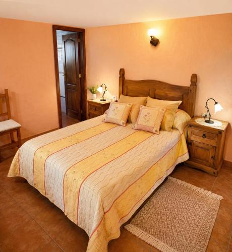 a bedroom with a large bed with two night stands at Villa Las Flores - Piscina privada - Private pool - by Rural La Palma in Tijarafe