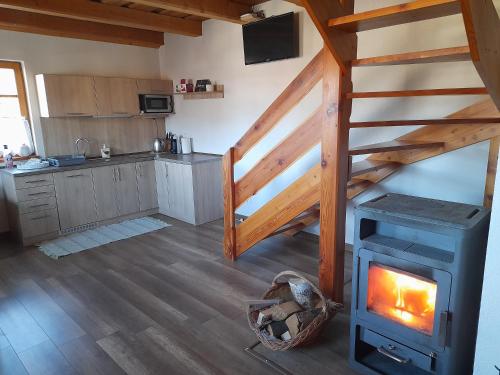 a kitchen with a wood stove in a room at Chata pod Urbanovym Vrchom in Čierny Blh