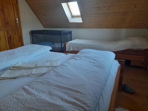 a room with three beds and a skylight at Chata pod Urbanovym Vrchom in Čierny Blh